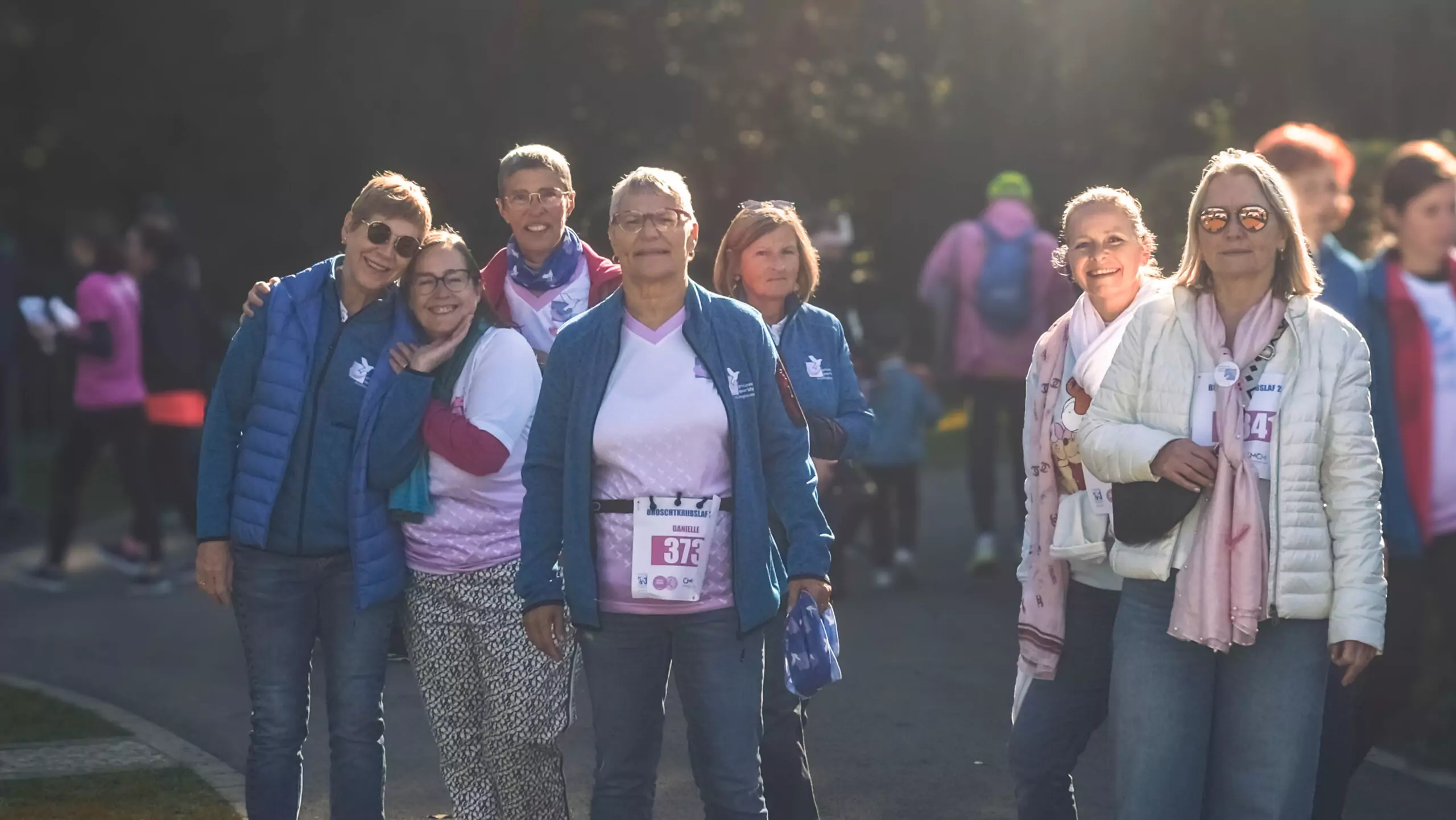 A group of ALGSO members smiling before crossing the finish line at the Broschtkriibslaf 2024